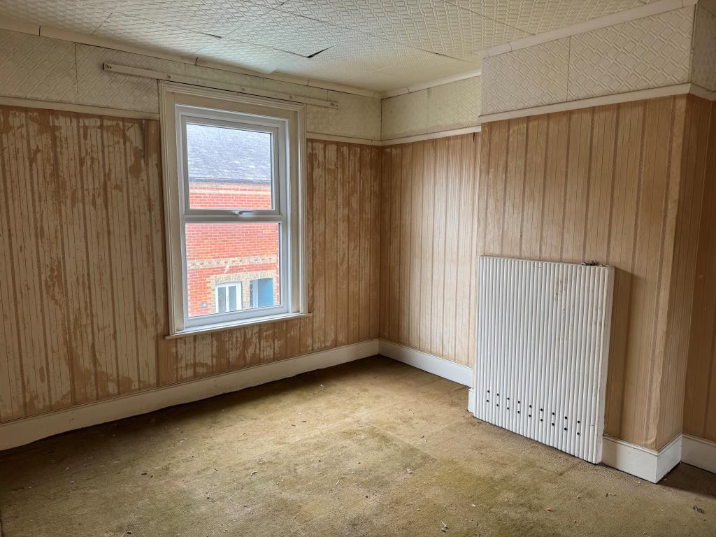 Lot: 133 - FREEHOLD TOWN CENTRE HOUSE FOR IMPROVEMENT - Bedroom with window and ceiling tiles